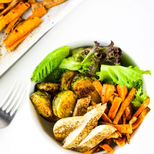 Chicken and roasted vegetables in a meal prep bowl.