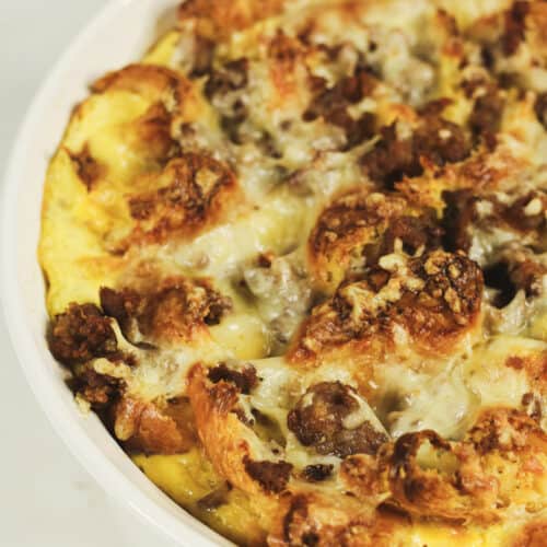 A croissant breakfast casserole with sausage, cheese, and eggs.