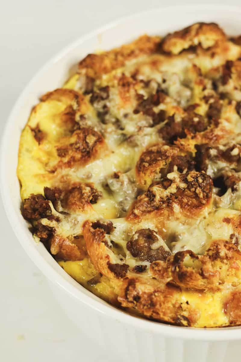 A croissant breakfast casserole with sausage, cheese, and eggs.