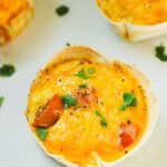 Tortilla egg quiche recipe made with eggs, cottage cheese, sausage, and cheese. High protein breakfast idea.